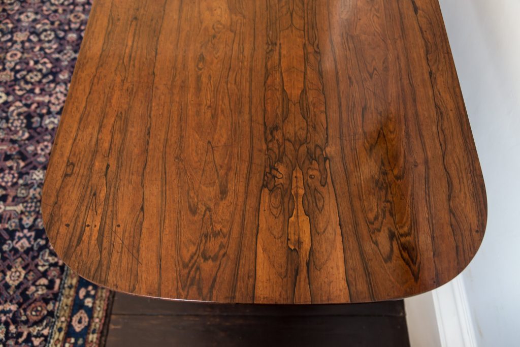 Showing rosewood veneered table top with character detail. Finely polished with a